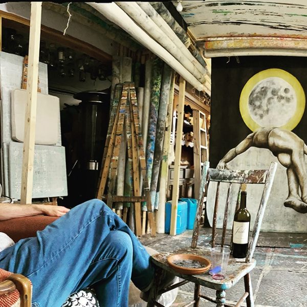Terry P. Daly in his art studio surronded by paintings